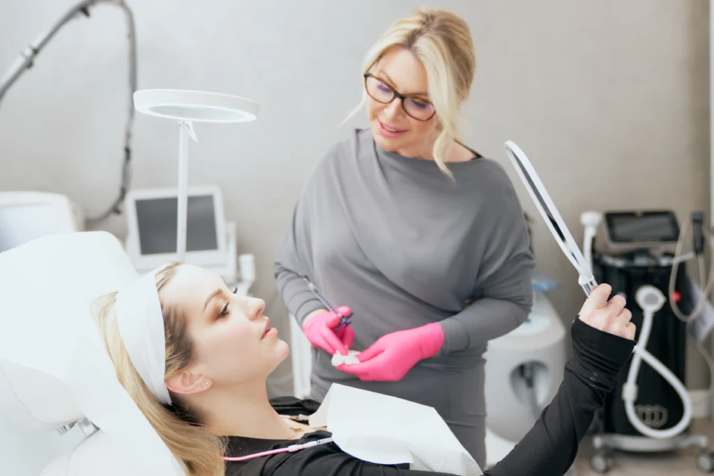 Woman consulting with a provider before receiving cosmetic fillers at a med spa.