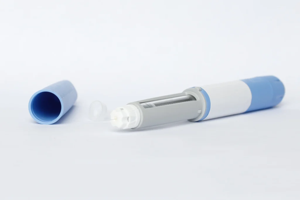 A blue and white medical injection pen used for weight loss treatments, placed on a white background.