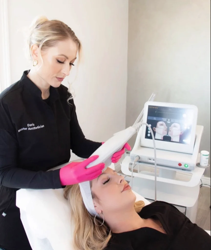 Ultherapy treatment being applied by an aesthetician using the device on a relaxed client.