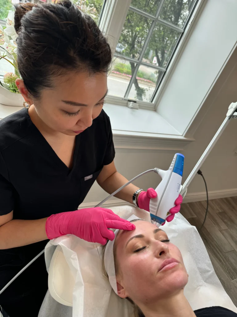technician performing facial rejuvenation with advanced device